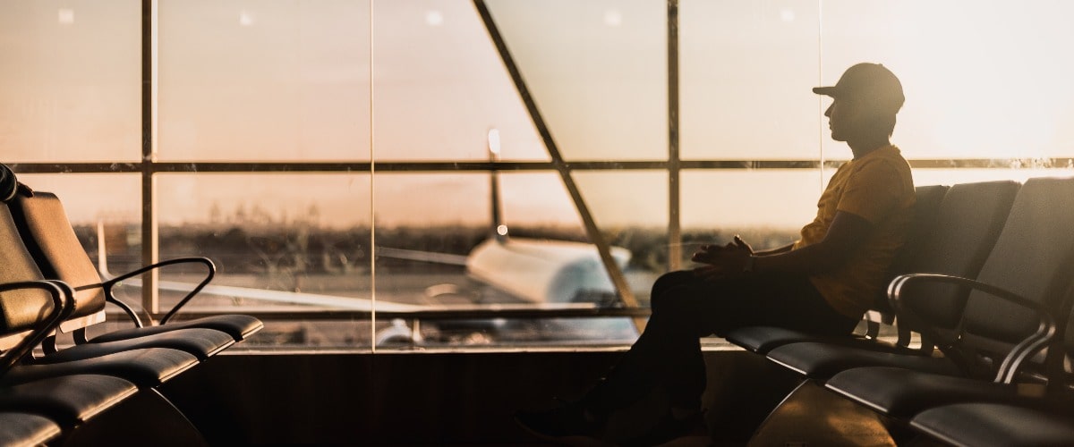 Man sitting in an airport | Alpha Airport Parking